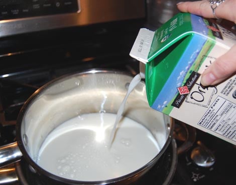 Pour in the milk to make Greek yogurt at HappySimpleLiving.com