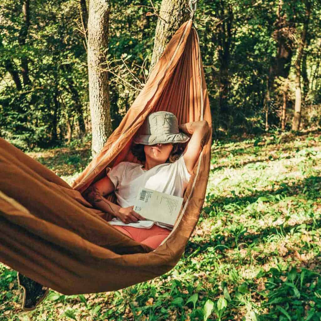 A woman napping in a hammock.