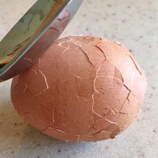 Crack hard cooked egg