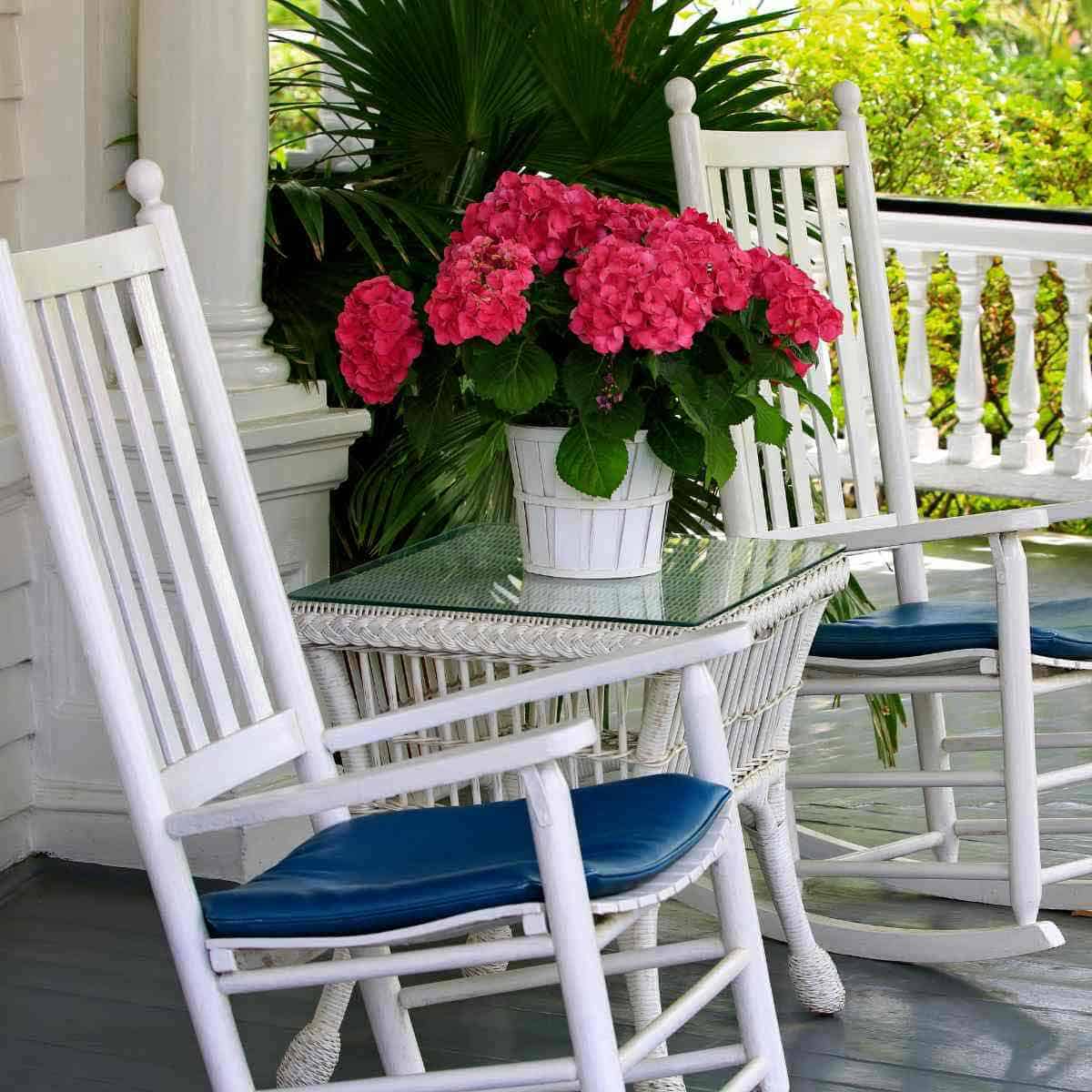Two rocking chairs on a front porch.