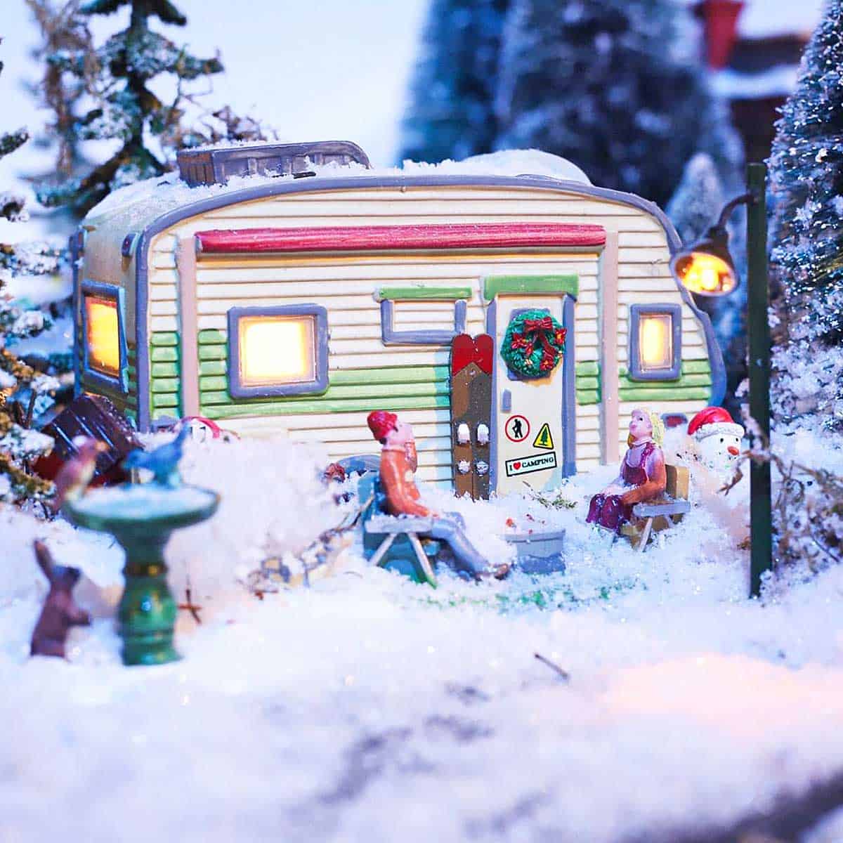 A Christmas toy trailer in a snow village.
