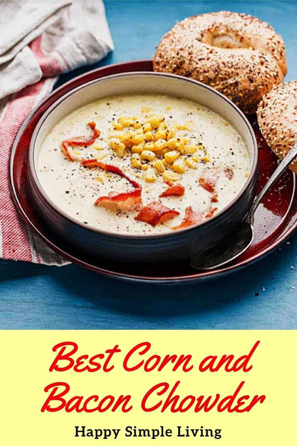 A bowl of corn chowder garnished with bacon, surrounded by toasted bagels on a plate.