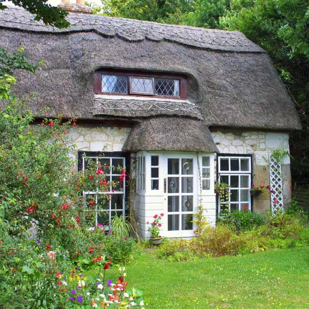 An English cottage with a thatched roof.