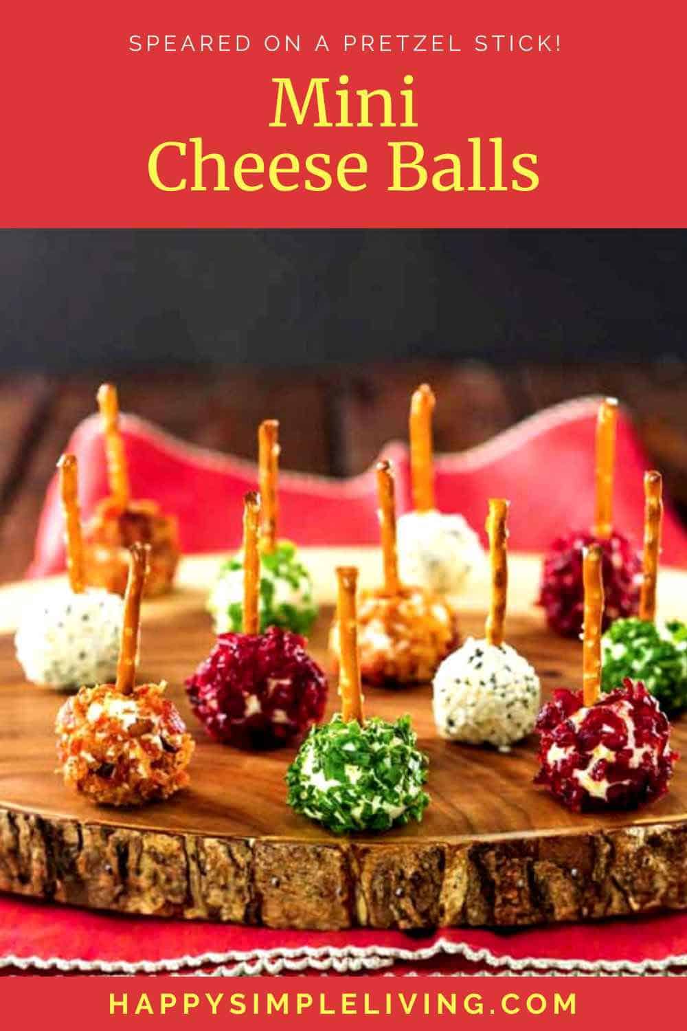 Mini cheese balls speared with pretzel sticks, served on a wooden platter.