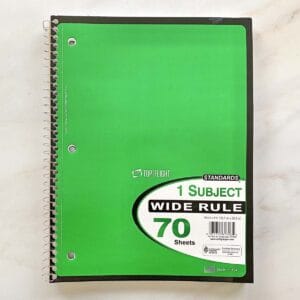 A bright green spiral notebook for writing about positive change.