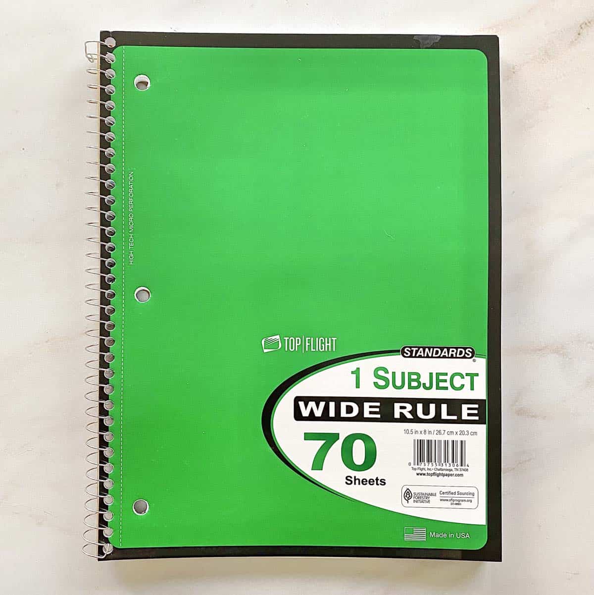 A bright green spiral notebook. 