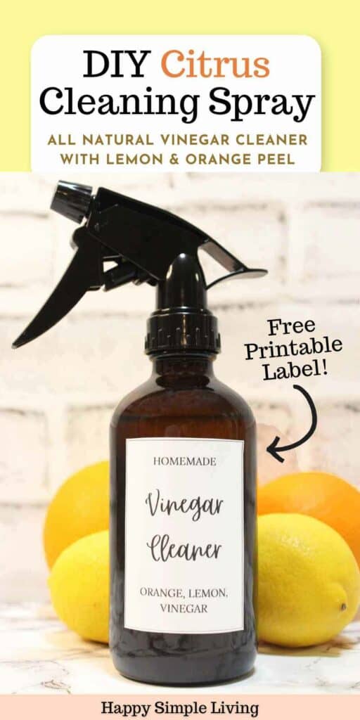 A brown spray bottle labeled Vinegar Cleaner Orange, Lemon, Vinegar is displayed against a white background with lemons and an orange at its base. Text reads, DIY Citrus Cleaning Spray with Free Printable Label! and Happy Simple Living.
