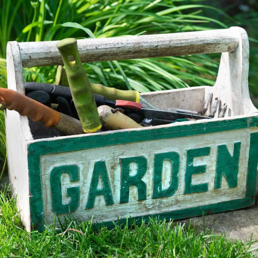 A gardening tool box with the word GARDEN on the side.