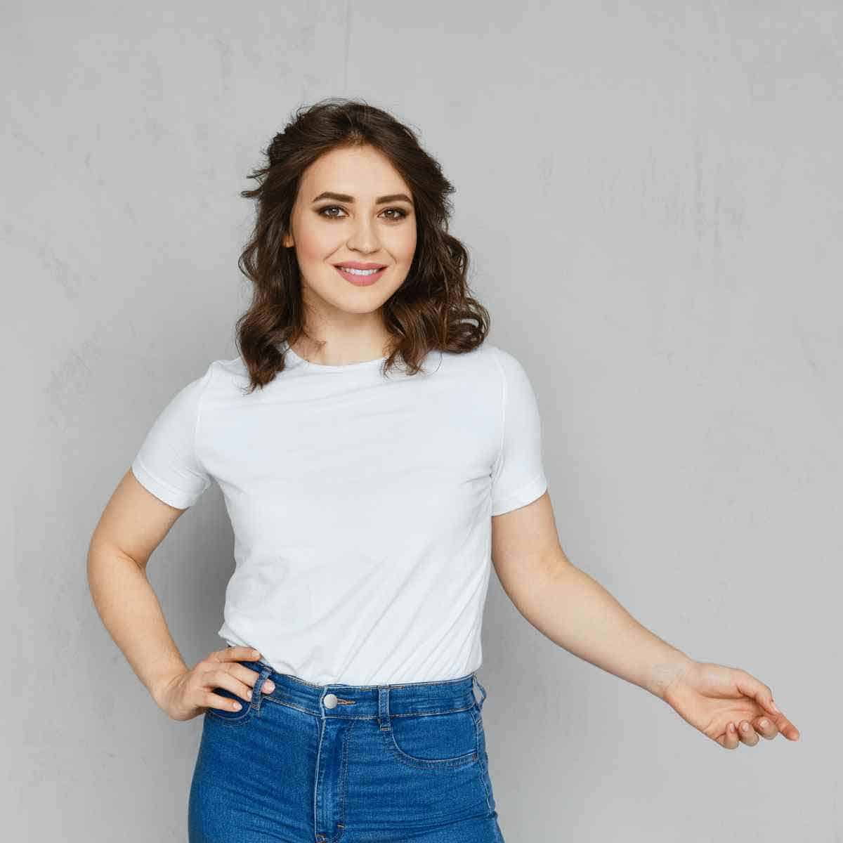 A young woman in a classic white t-shirt and blue jeans.