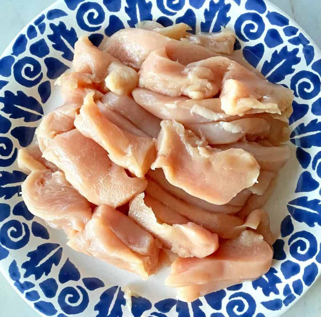 Boneless chicken breasts sliced and cut in nugget sized pieces.