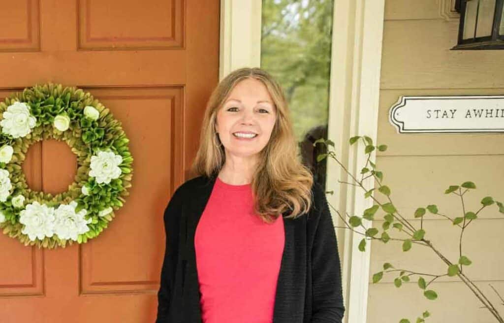 Happy Simple Living founder Eliza Cross standing by a door.