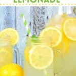 A glass and a pitcher of homemade lemonade with lemons.