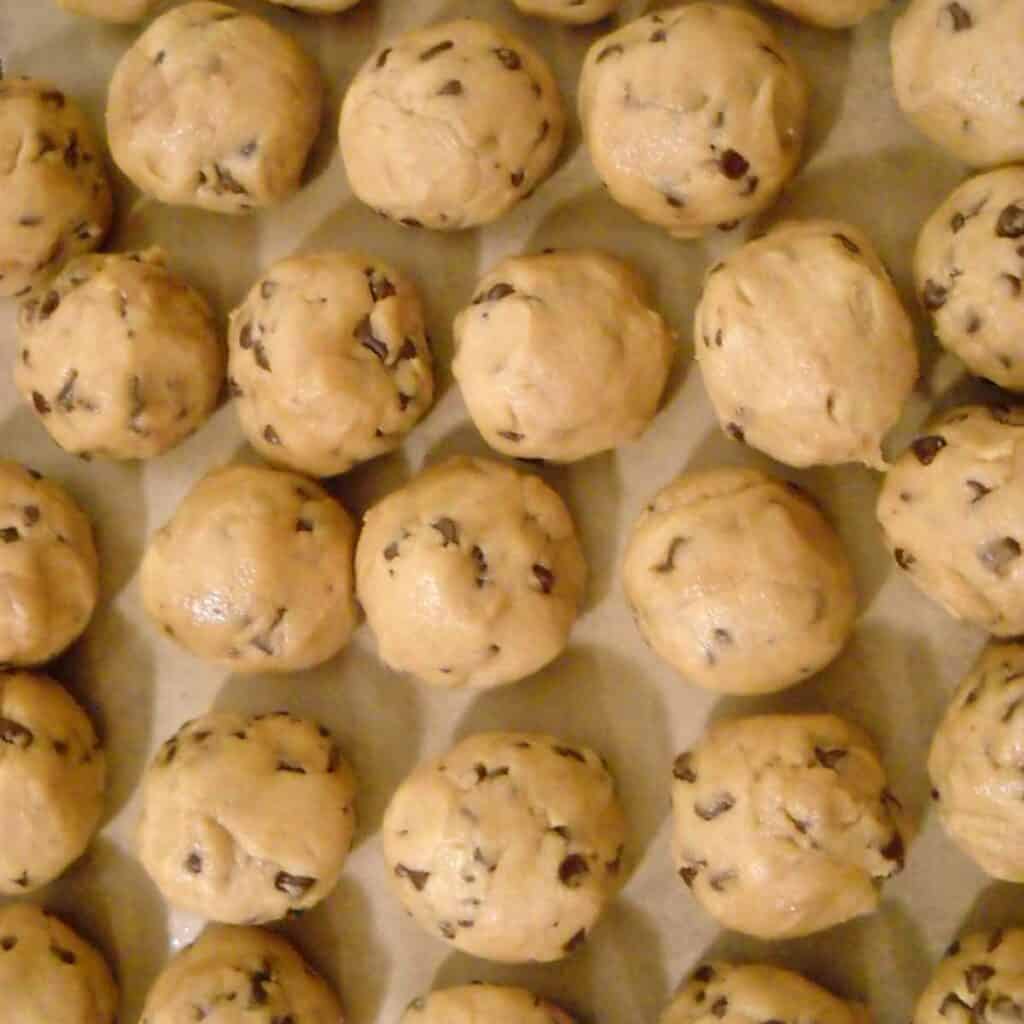 Chocolate chip cookie dough balls ready for freezing.
