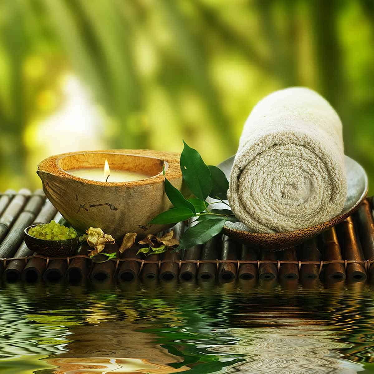 A candle, rolled up towel and bamboo mat.