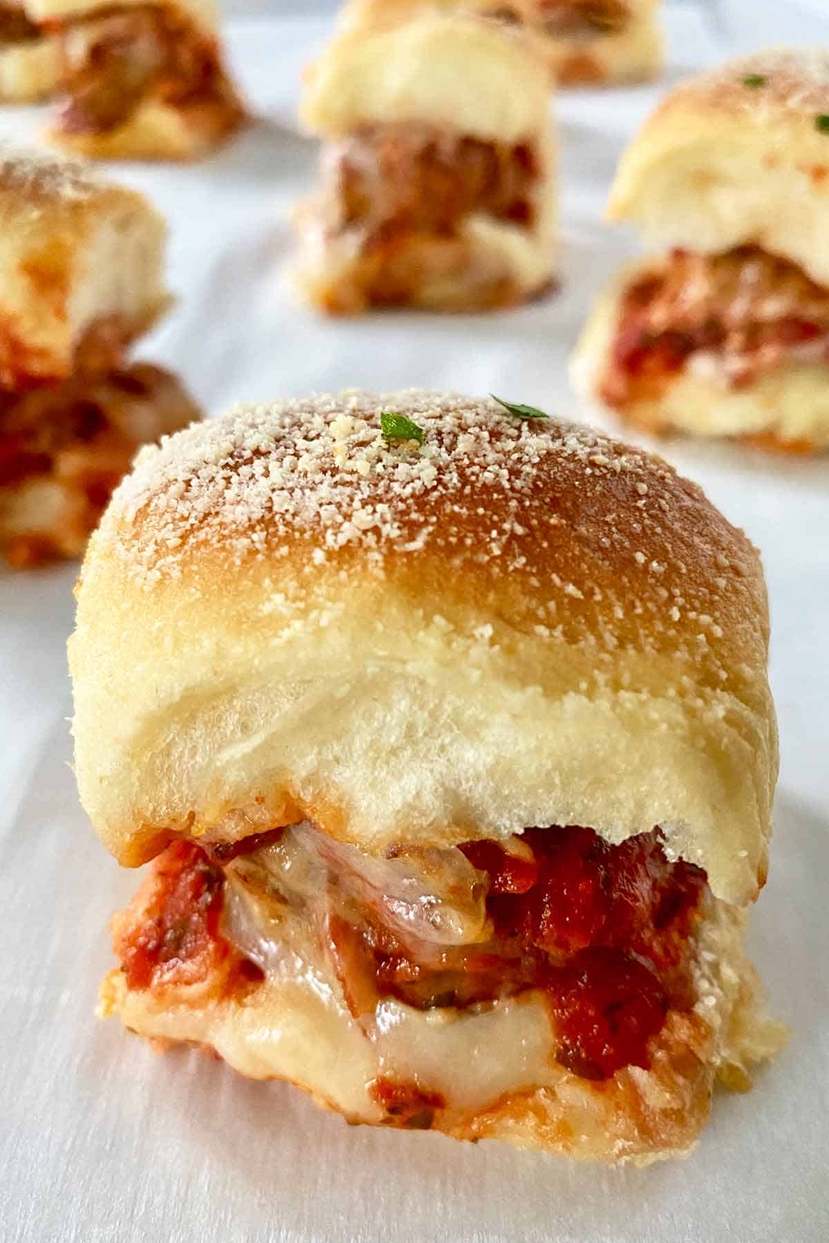 A meatball slider up close, with five more in the background.