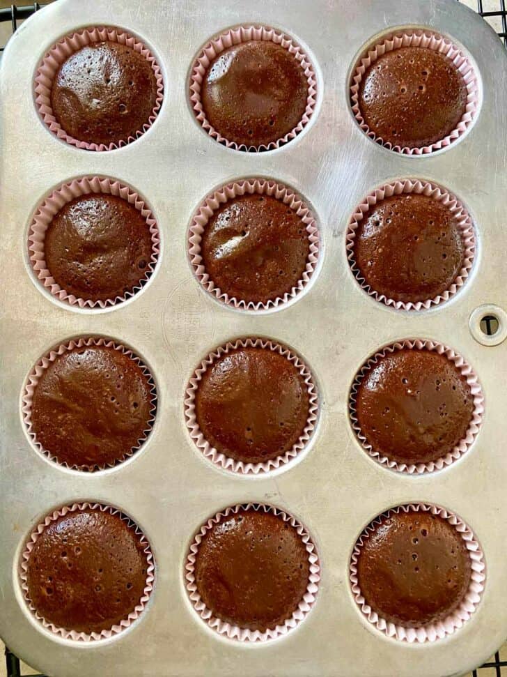 Baked miniature chocolate cakes in a mini muffin pan.