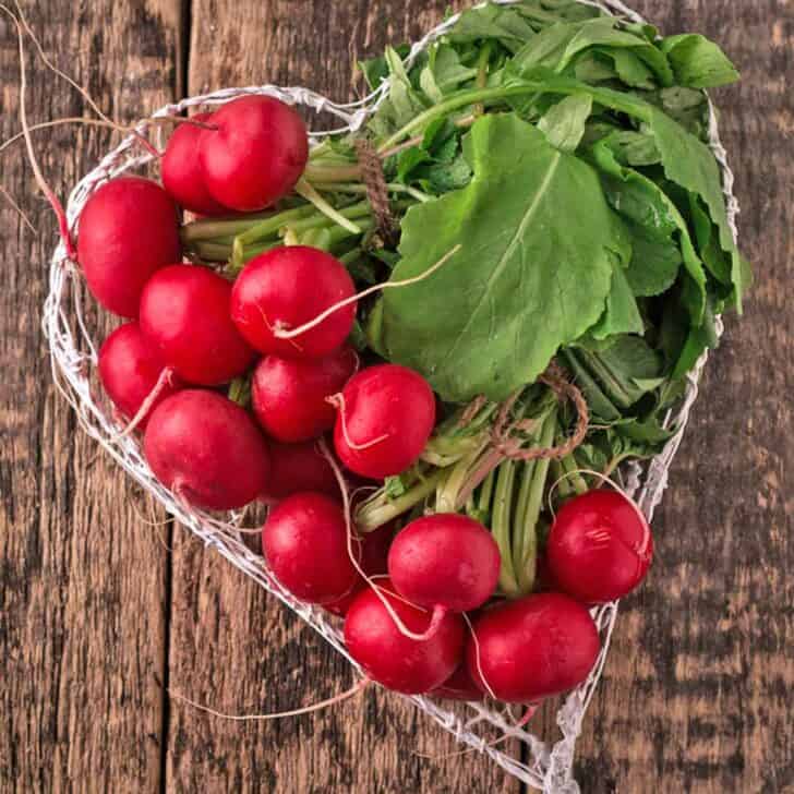 Homegrown radishes in a heart shaped basket.