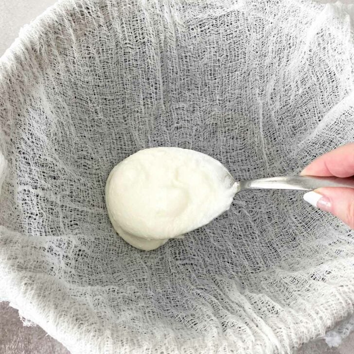Adding yogurt to a cheesecloth lined strainer.