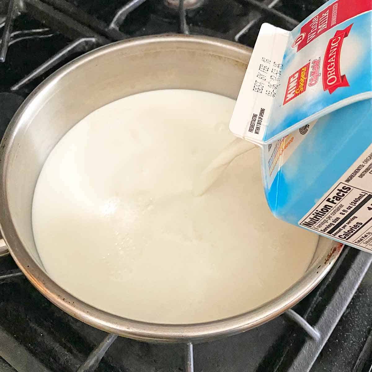Pouring milk into a heavy saucepan.