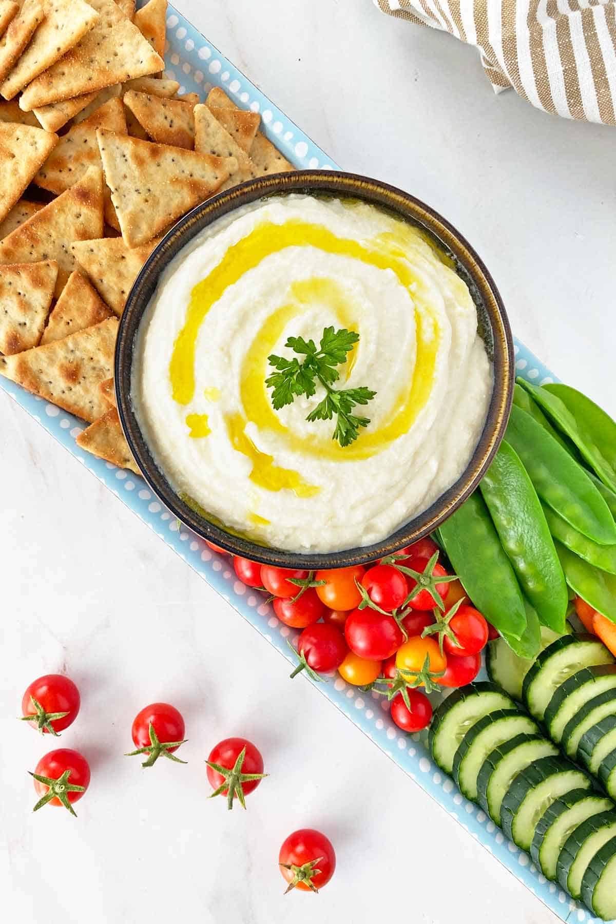 Whipped ricotta with cherry tomatoes, peas, cucumbers and crackers.