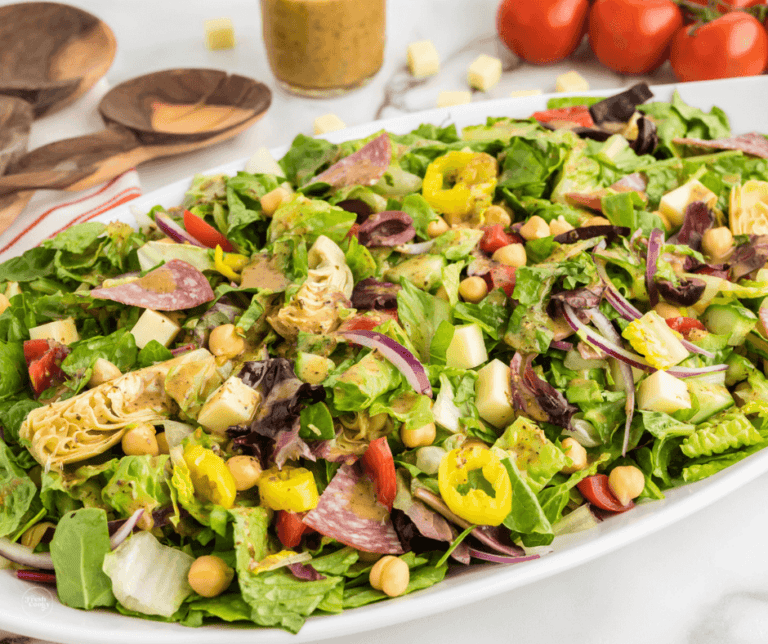 A large white platter filled with chopped salad.