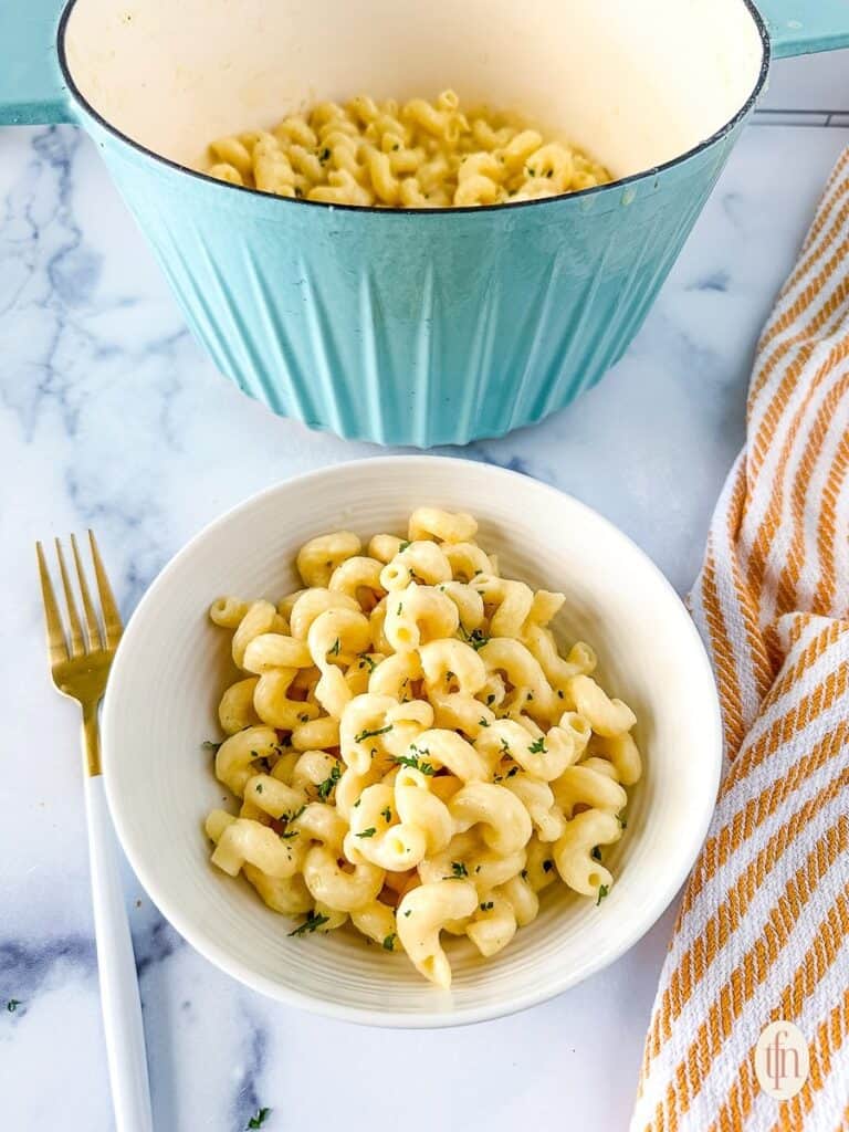 A serving bowl with white cheddar macaroni and cheese.