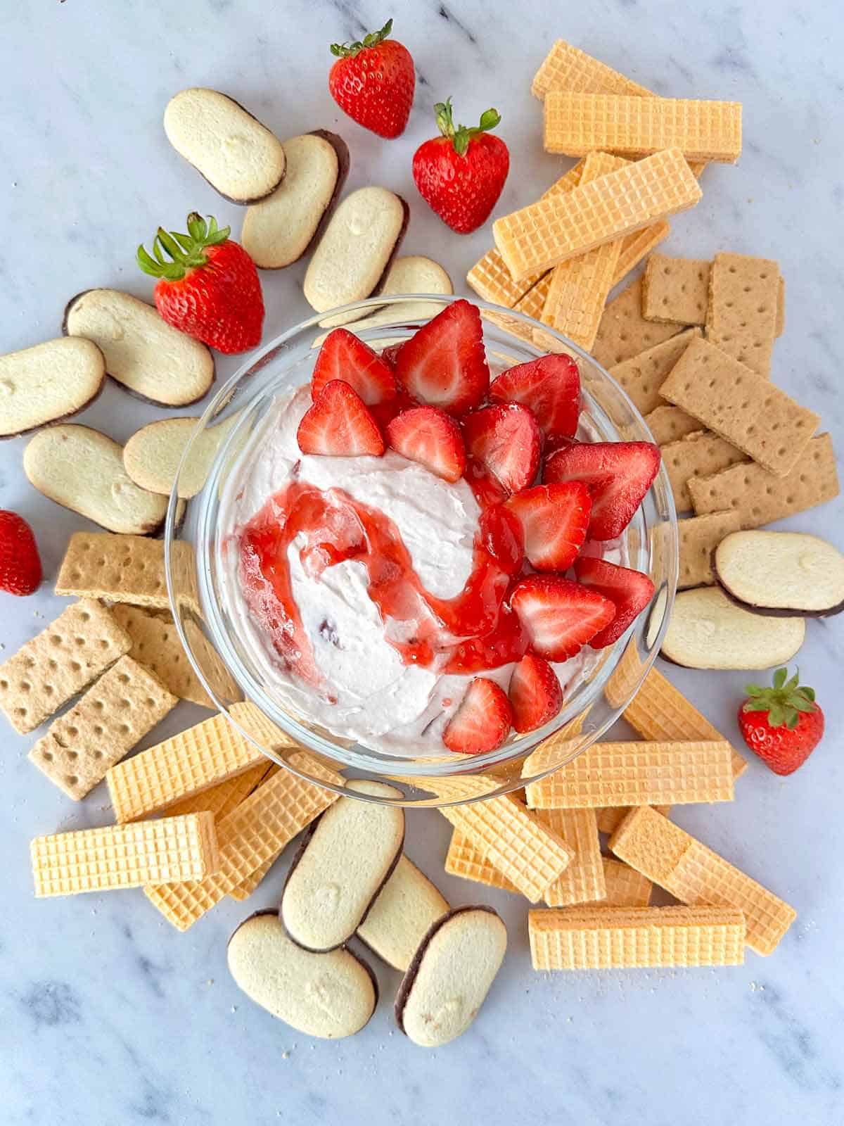 Strawberry cheesecake dip with milano cookies, sugar wafer cookies and graham crackers.