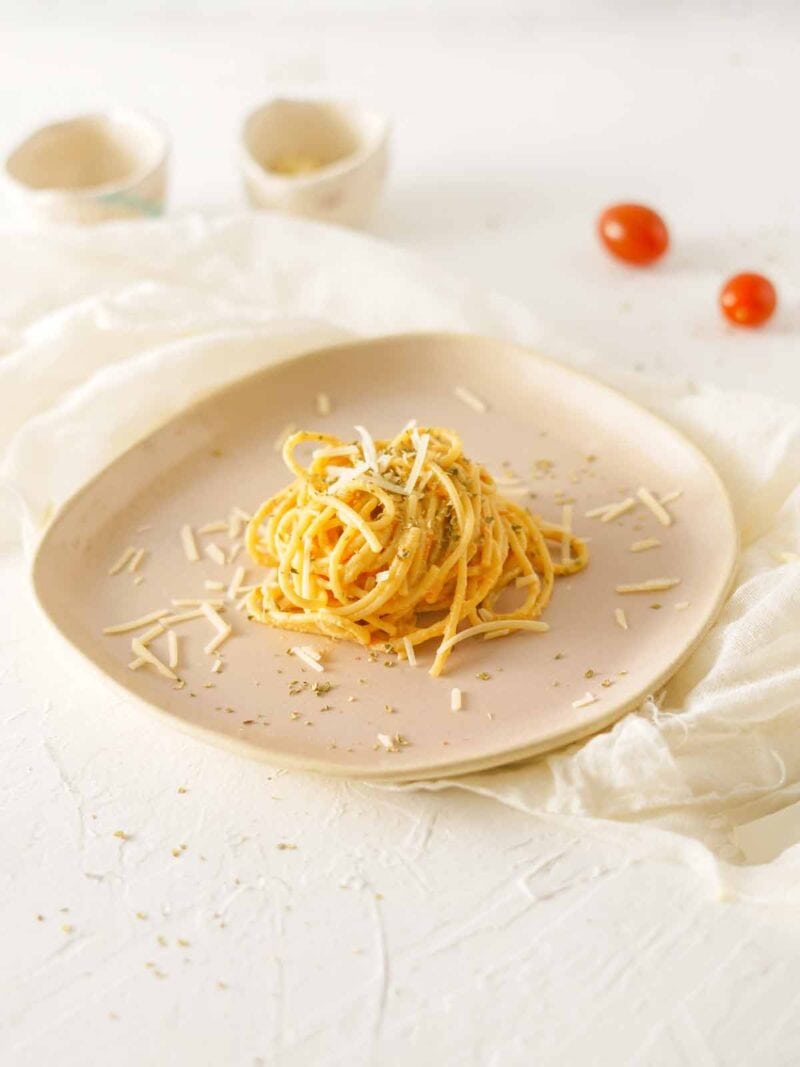 A portion of pasta with burrata tomato sauce on a plate.