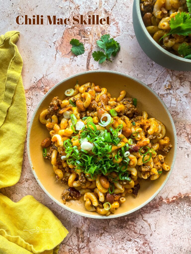 Homemade chili mac skillet in a white and yellow bowl.