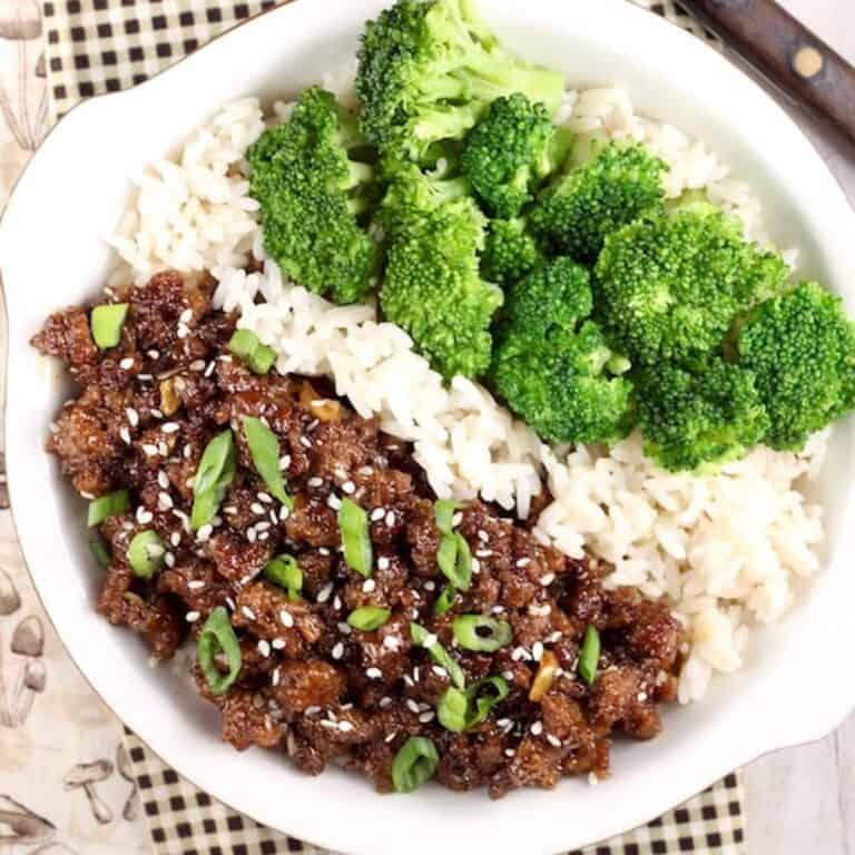 Beef, broccoli and rice on a white plate.
