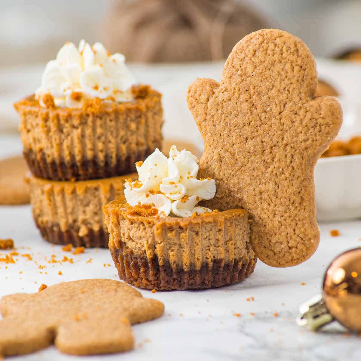 Three mini ginger cheesecakes and a gingerbread man cookie.