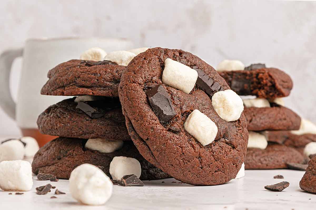 A stack of hot chocolate cookies with mini marshmallows and chocolate chunks.