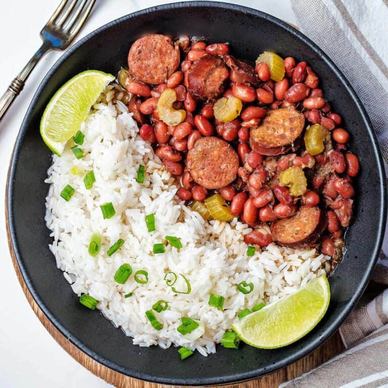 Red beans and rice on a black plate.