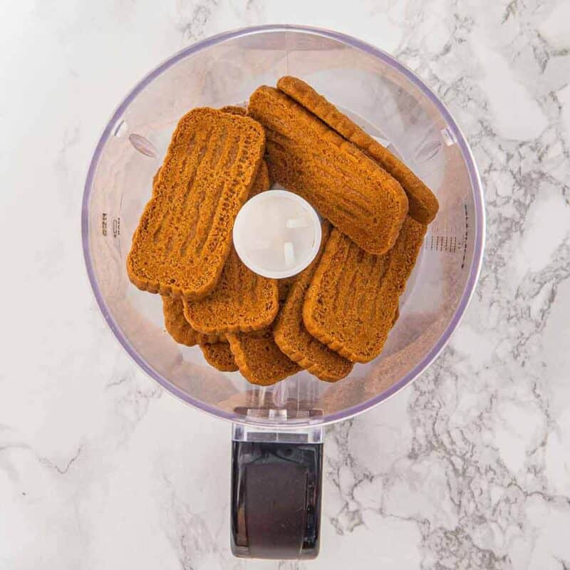 Biscoff cookies in a food processor before being crushed.
