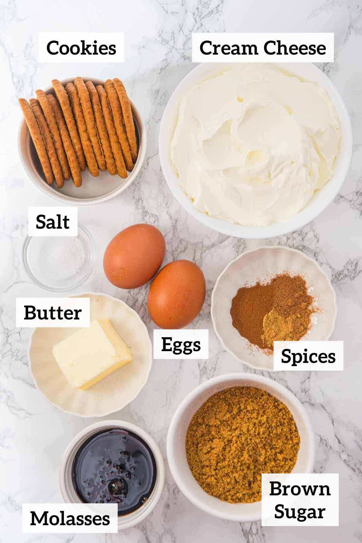 Cream cheese, cookies, eggs, salt, spices, butter, brown sugar and molasses to make mini ginger cheesecakes.