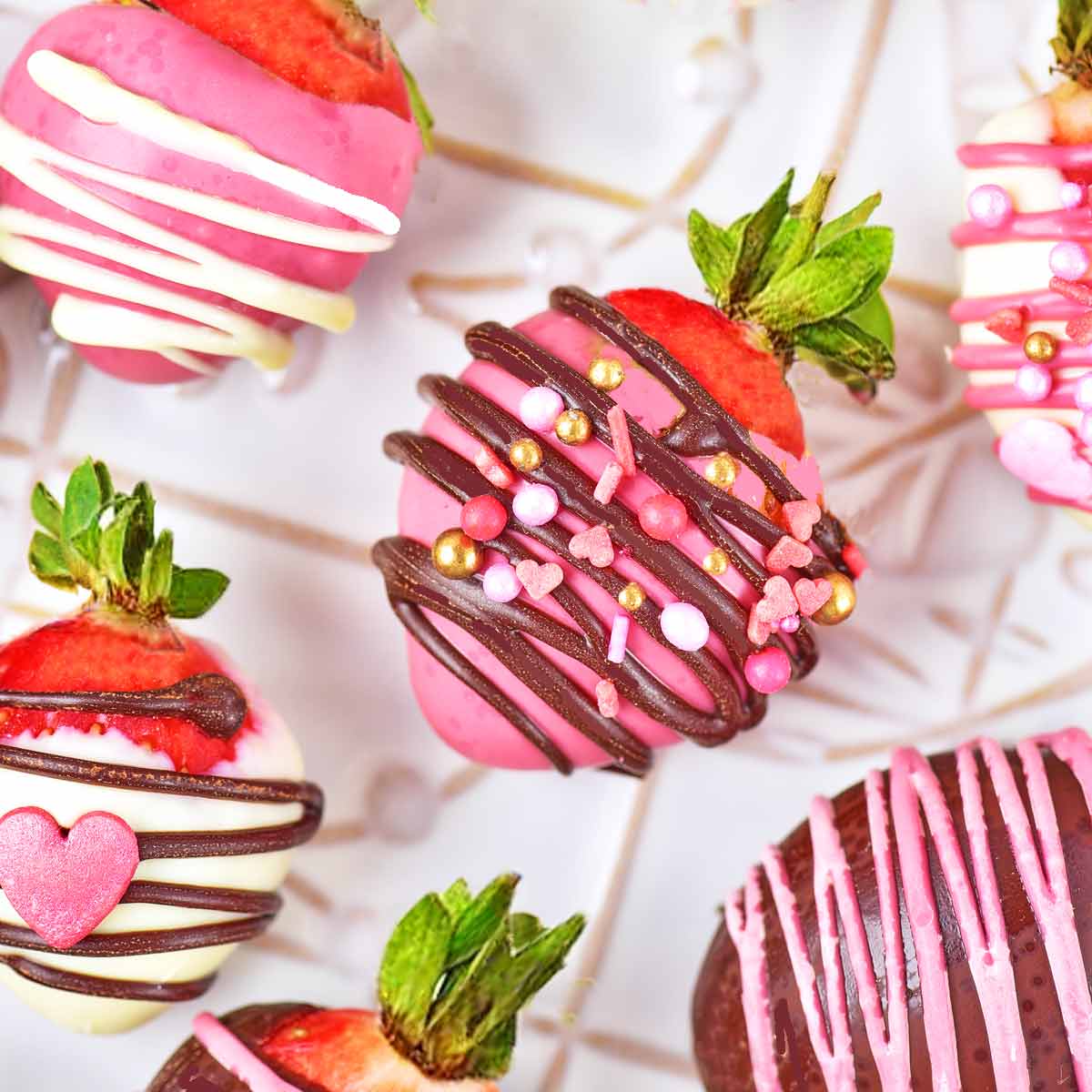 Six chocolate covered strawberries topped with sprinkles.