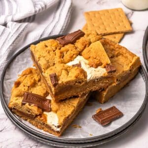 Three s'mores cookie bars on a small plate.