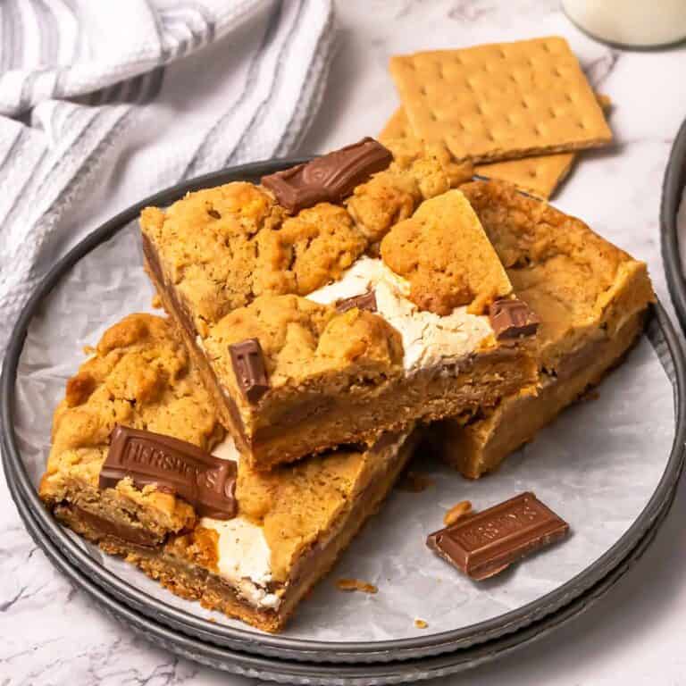 Three s'mores cookie bars on a small plate.