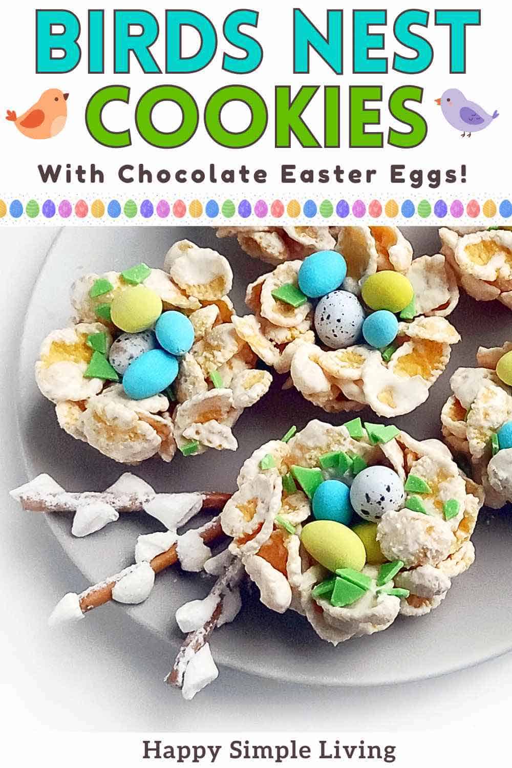 Three birds nest cookies with cornflakes, mini Easter eggs and white chocolate, on a serving plate.