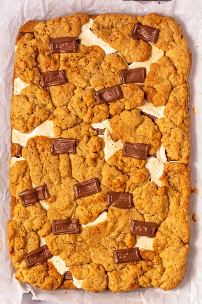 Baked s'mores cookie bars on a piece of parchment paper.