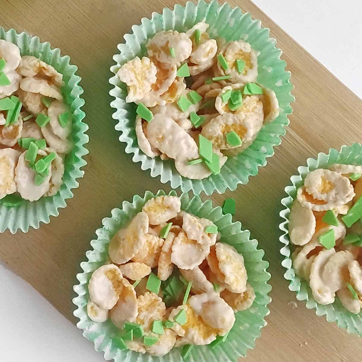 Corn flake nest cookies sprinkled with chopped green chocolate.