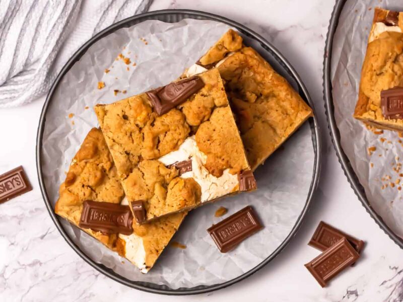 Three s'mores bars on a plate.