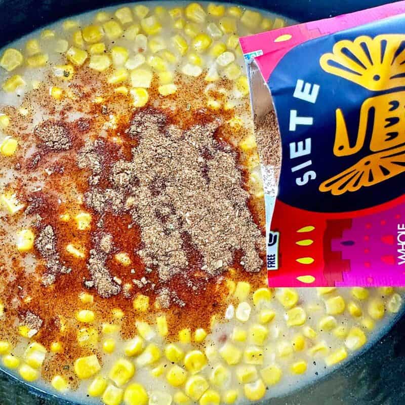 Combining ingredients for creamy chicken tortilla in a crock pot.