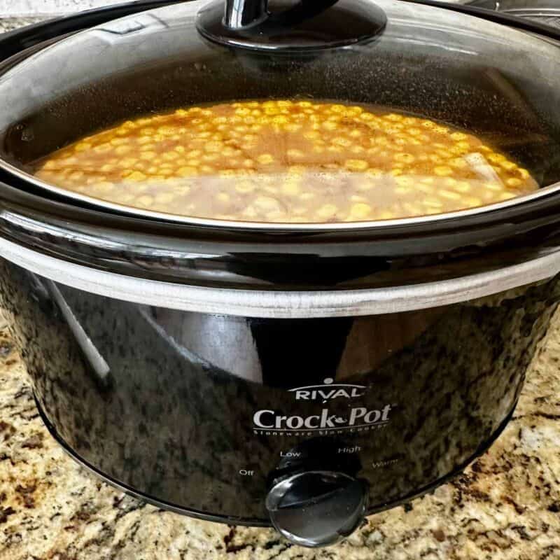 Chicken tortilla soup slow cooking in a Crock Pot.