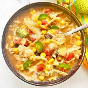 Bowl of creamy chicken tortilla soup with spoon.