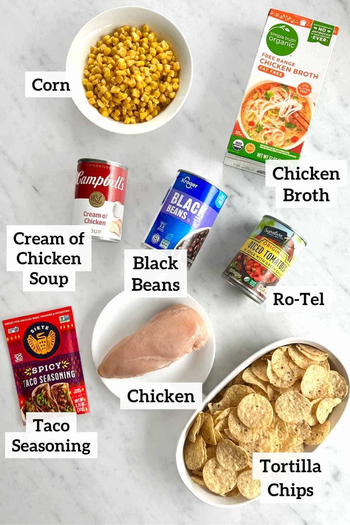 Corn, chicken broth, black beans, chicken soup, tacon seasoning, chicken, tortilla chips, and Ro-Tel.