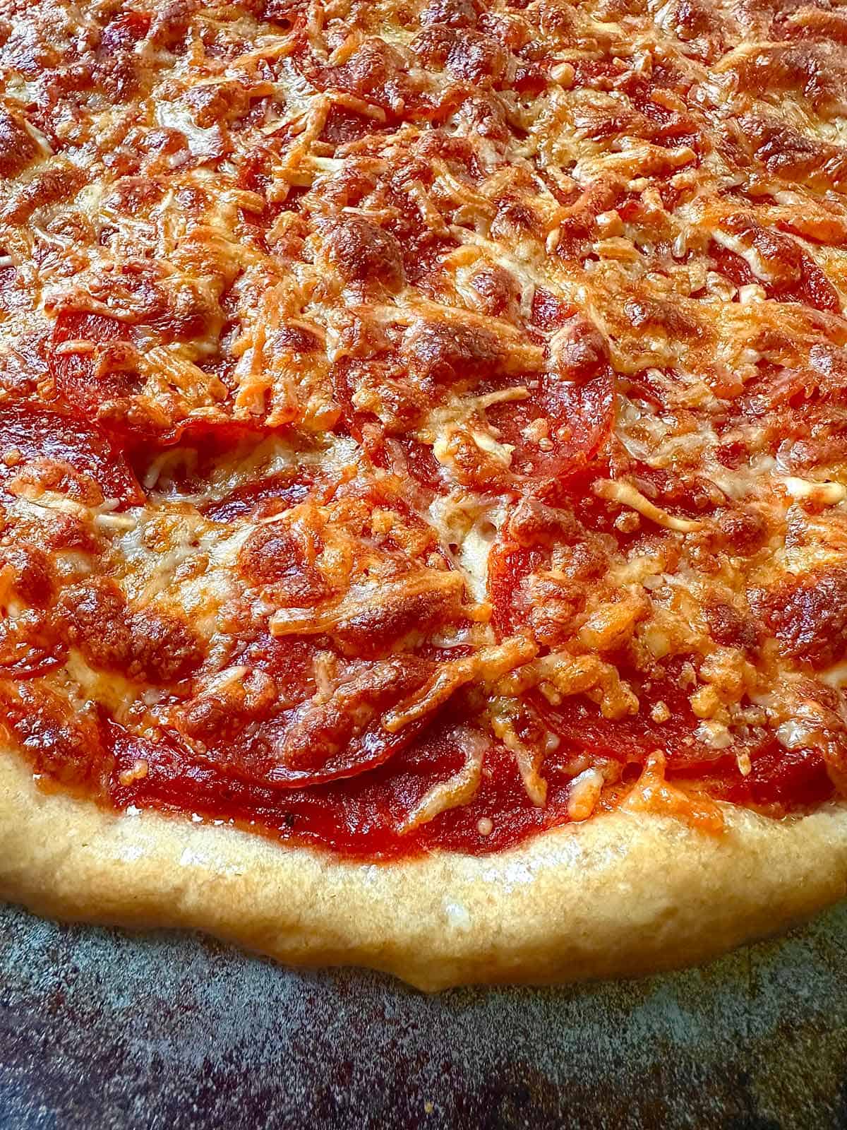 Pepperoni pizza just baked in a home oven.