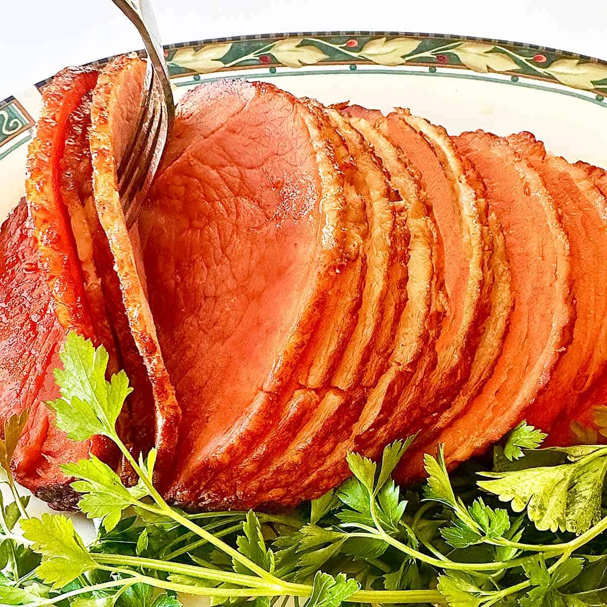 A spiral ham with honey glaze ready for serving.